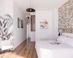 Chambre hell Gassien Paris mit Regale Messing, mur en pierre und parquund Holz Naturl.